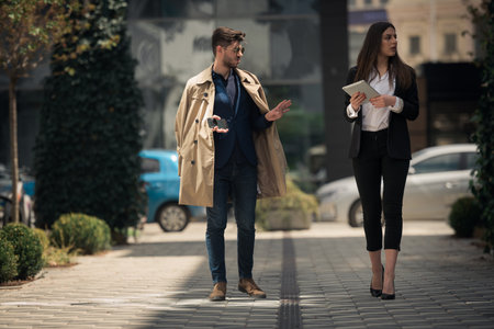 Business partners are walking and talking about their new companyの写真素材