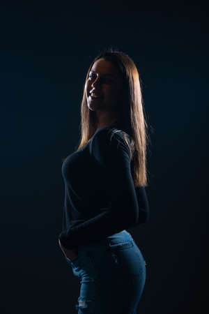 Silhouette picture of beautiful woman posing on black backgroundの写真素材