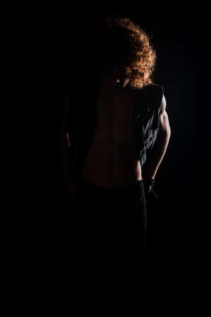 Teenager boy with afro hairstyle isolated on a black backgroundの写真素材