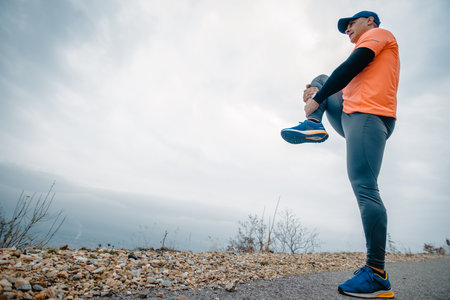 Athletic man over 40 dressed in sportswear during a stretching routine