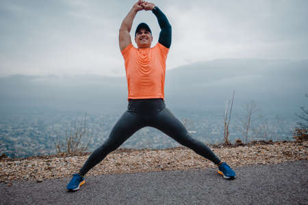 Mature man over 40 wearing sport clothes preparing for a jogging exercise