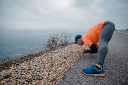Fit muscular man wearing fitness clothes preparing for a run