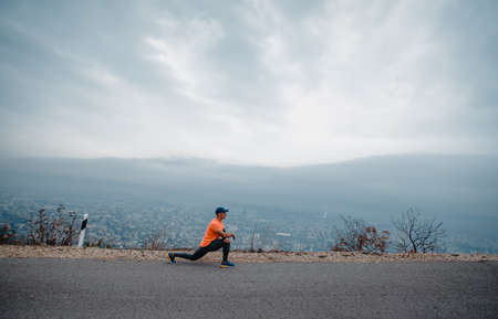 Healthy middle aged man during preparation for a jogging exerciseの写真素材