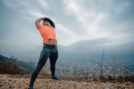 Athletic man over 40 dressed in sportswear during a stretching routineの写真素材