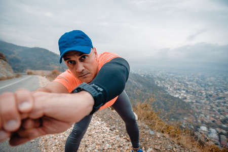 Fit athletic man over 40 in activewear stretching out his bodyの写真素材