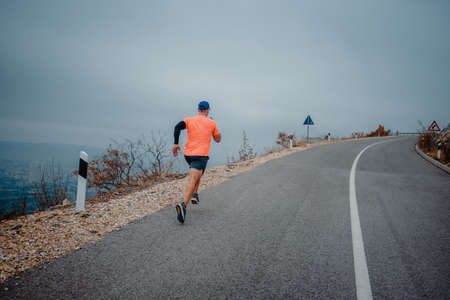 Fit mature man dressed in sportswear working out outdoorsの写真素材