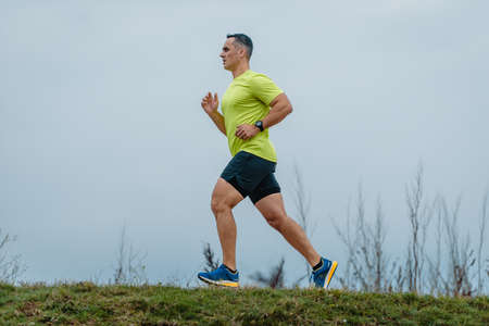 Fit man over 40 wearing activewear during a running exerciseの写真素材