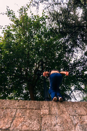Parkour man exercising while jumping of the wallの写真素材