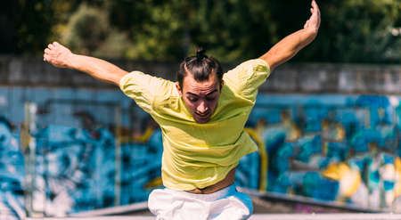 Parkour man training hard while run through obstacles in skateparkの写真素材