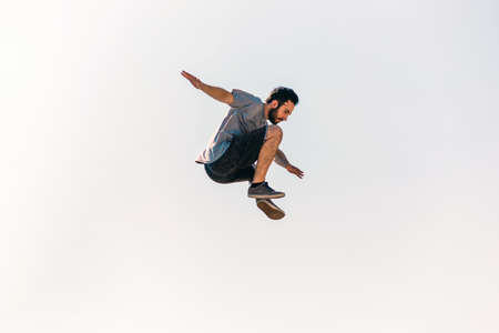 Sports man training parkour while jumping in the airの写真素材