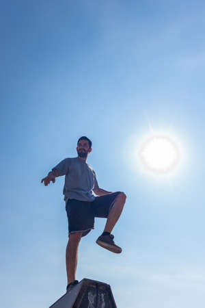 Sporty man maintains a balance on pyramid in skateparkの写真素材