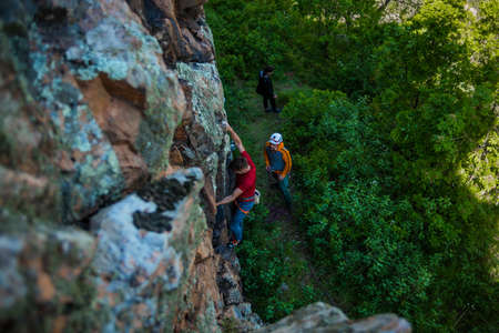 Friends preparing to go rock climbing and untangling the rope