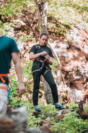 Young climber team prepare their safety harness belt forの写真素材
