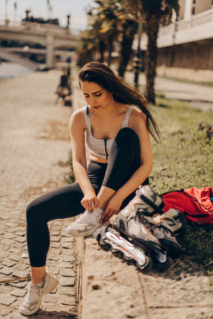 Handsome girl is roller skating on a sunny day in down townの写真素材