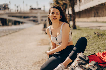 Happy teenager on rollerblading sitting on street a sunny day. active lifestyleの写真素材