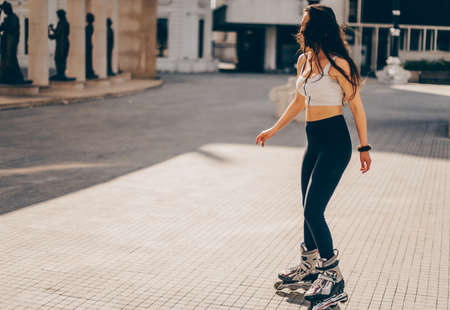 Girl riding on roller skates in skatepark summer outdoor