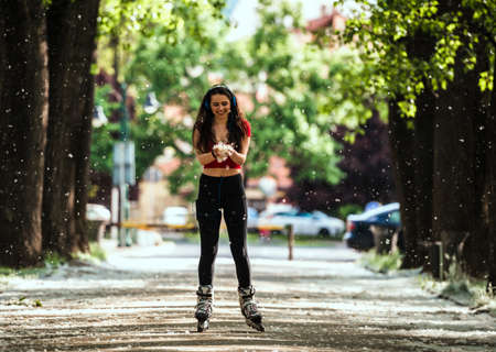 Female legs in inline skates in action outdoors on sunny day. Fun time activityの写真素材