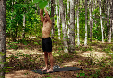 Portrait of a young handsome man doing exercises at the park. healthy concept. Outdoors.