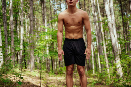 Athlete warming up and preparing or workout. Male runner doing stretches outdoor. Sports conceptの写真素材