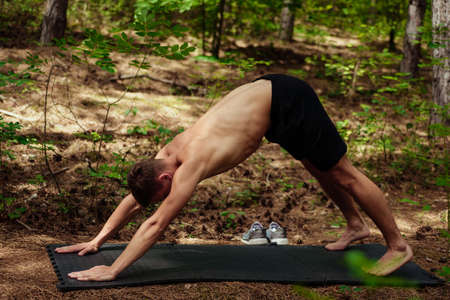 Healthy lifestyle fitness sporty man stretching before run early in the morning in mountain area