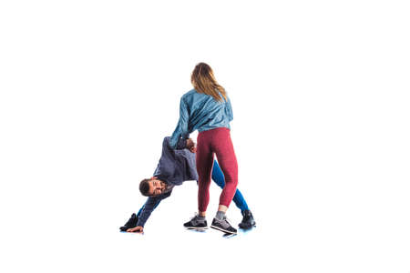 Couple is showing aerobic moves in isolated room