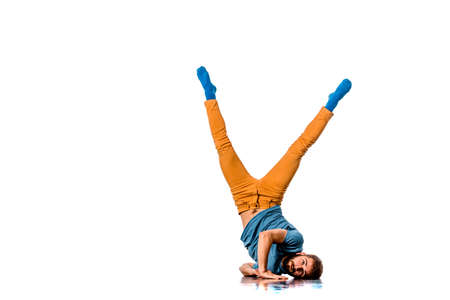 Breakdancer does expressive move and handstand isolated on whiteの写真素材