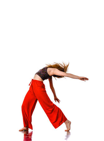 Blonde woman aerobics instructor perform stunt passionately while looking upの写真素材