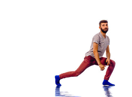 Portrait of a young man dancing of joy. Isolated image on white backgroundの写真素材