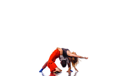 A couple of young man and woman dancing hip-hop at studio