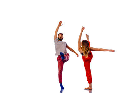 Couple of hip-hop dancers is dancing. Girl and boy performing street dance on white background....