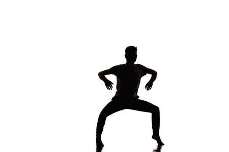 Disco dancer showing some movements against isolated white backgroundの写真素材