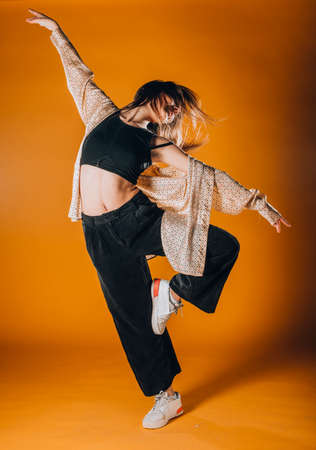 Flexible young dancer performing a stylish dance movementの写真素材