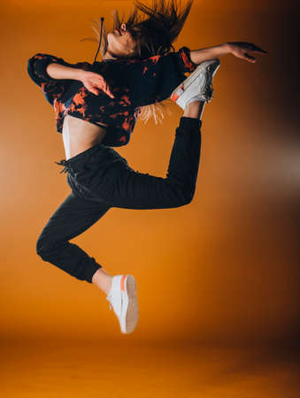 Dance moves performed by an acrobatic flexible female dancerの写真素材