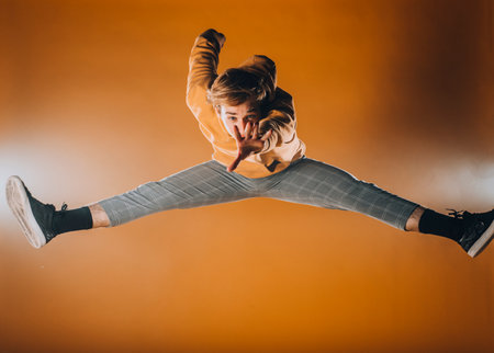 Young athletic man performing contemporary dance movesの写真素材