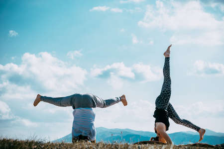 Balance your life. Young couple meditating together while doing yoga. Yoga concept. Healthy lifestyleの写真素材