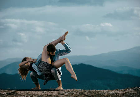 Full length view of a couple of female and male urban dancers performing and freestyling with some musicの写真素材