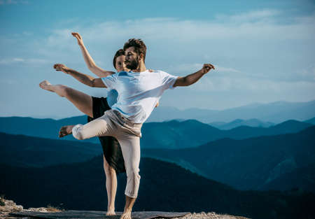 Young handsome dancer dancing hip-hop. Pretty woman dancing on the backgroundの写真素材