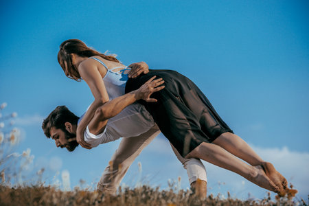 Young beautiful barefoot couple dancer practicing modern danceの写真素材