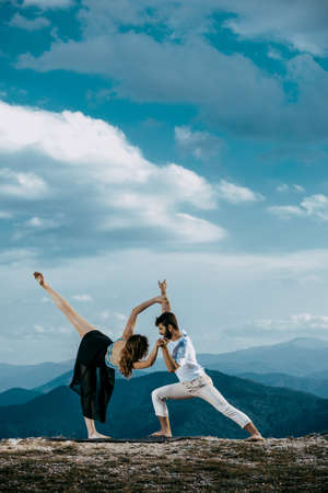 Contemporary dance. Man and woman in passionate dance pose in park. Young couple dancing modern danceの写真素材