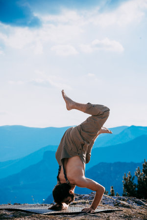 Portrait of a good looking Hispanic male dancer freestyling outdoors doing handstandの写真素材