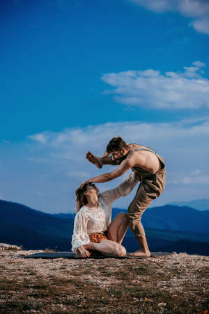 Skillful hip-hop dancers in movement. Young couple of modern dance dancing on the cliffの写真素材