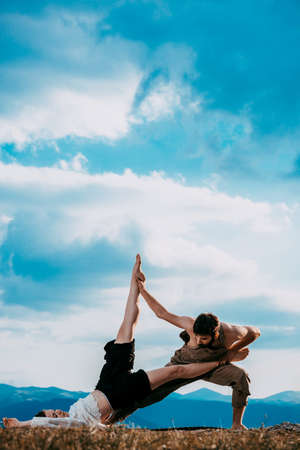 Sensual couple performing an artistical and emotional contemporary dance at mountainの写真素材