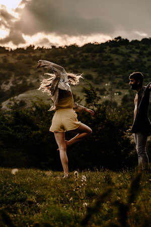 Sensual couple performing an artistical and emotional contemporary dance on mountain fieldの写真素材