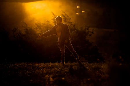 Summer holidays, love, relationship and dating concept - smiling couple dancing on the mountain peakの写真素材
