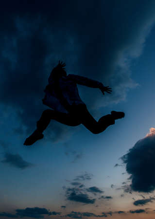 Man dancer, in beautiful dynamic jump action figure on the sky backgroundの写真素材