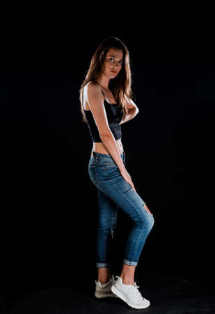 Portrait of a sexy stylish girl posing in trendy modern clothesの写真素材