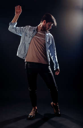 Portrait of a handsome young urban guy while posing in fashion studio