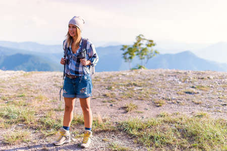 Young woman prepare to hike in the forest in the summer. Hiking concept in the mountainの写真素材