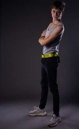 Stylish fashion guy posing against dark backgroundの写真素材