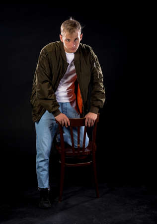 Attractive stylish man posing in casual cothing isolated on black backgroundの写真素材